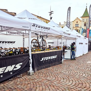 The Stevens Bikes promotion tent is a 4x2 m folding gazebo in white. The side walls are black and white. The bikes are located under the folding gazebo.